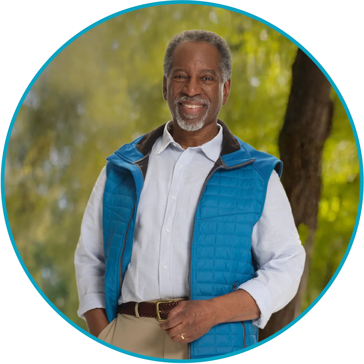 Man in blue vest smiling